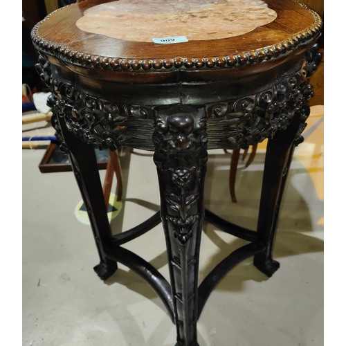 458 - A Chinese hardwood stand with lotus shaped marble top, carved decoration with pierced rim and dragon... 