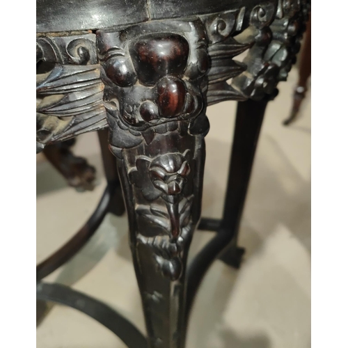 458 - A Chinese hardwood stand with lotus shaped marble top, carved decoration with pierced rim and dragon... 