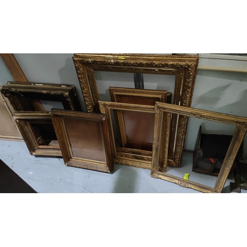 855A - A selection of large antique gilt picture frames with various designs and sized, largest overall 99 ... 