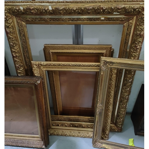 855A - A selection of large antique gilt picture frames with various designs and sized, largest overall 99 ... 