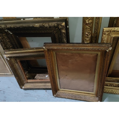 855A - A selection of large antique gilt picture frames with various designs and sized, largest overall 99 ... 