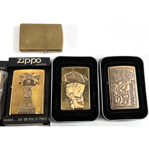 112 - Seven brass or gilt covered cased Zippo lighters - 1 plain, two with incised floral decoration, anot... 