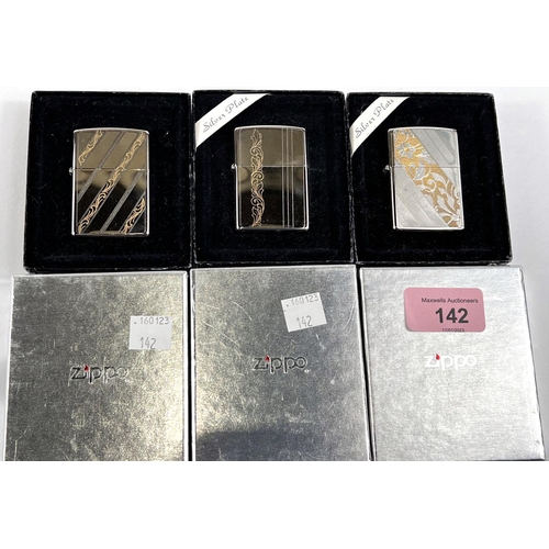 142 - Three silver plated Zippo lighters with incised gilt decoration, boxed, Models 103WG, 102WG & 10... 