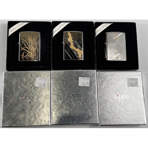 142A - Three silver plated Zippo lighters with incised gilt decoration, boxed, Models 108WG, 109WG & 11... 