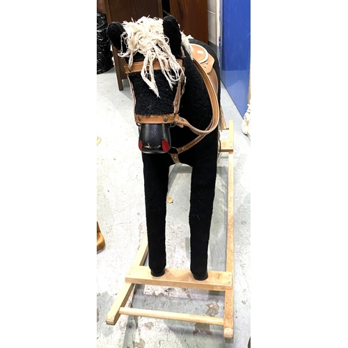 20 - A modern rocking horse, black fur effect body, cream wool mane and tail with leather effect saddle