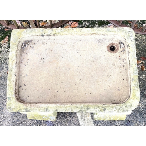 3 - An old stone sink on end supports