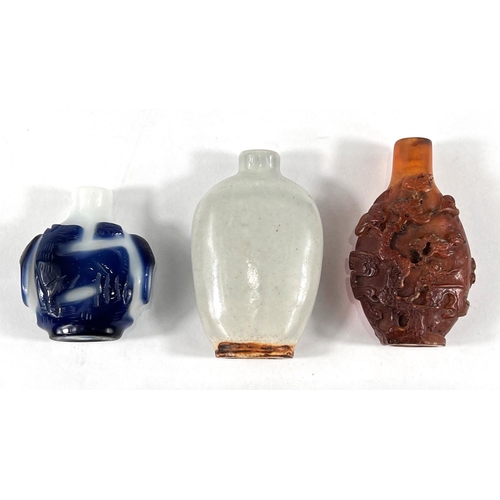 371 - Three Chinese snuff bottles, a blue and white snuff bottle with horse decoration, a celadon snuff bo... 