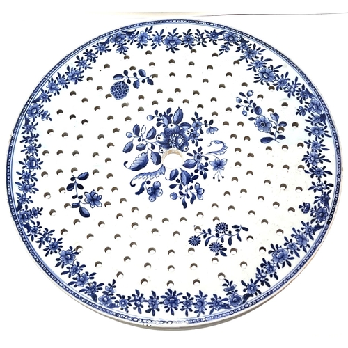 374 - A Chinese 18th century blue and white strainer of circular form, with plant and floral decoration, l... 