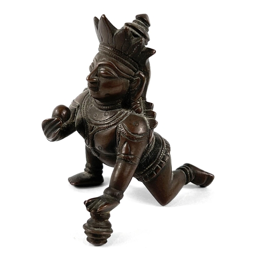 379 - A 19th century Indian bronze weight depicting Chrishna kneeling, height 9cm