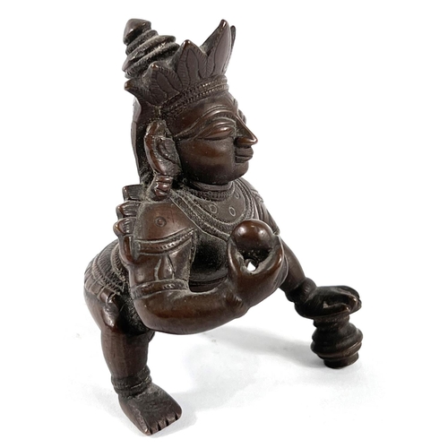 379 - A 19th century Indian bronze weight depicting Chrishna kneeling, height 9cm