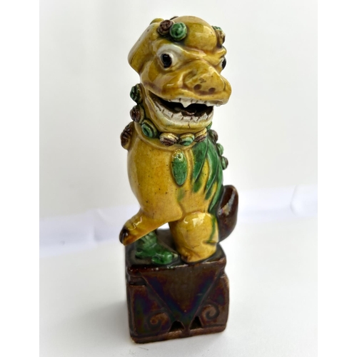 382 - A 19th century Chinese ceramic dog, in yellow and brown glaze, height 14cm