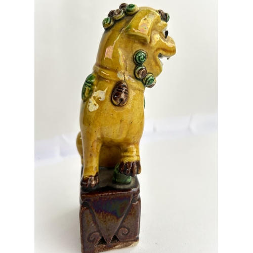 382 - A 19th century Chinese ceramic dog, in yellow and brown glaze, height 14cm