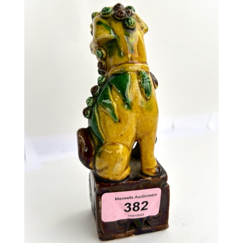 382 - A 19th century Chinese ceramic dog, in yellow and brown glaze, height 14cm