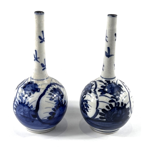 409 - A pair of Chinese blue and white bottle vases with floral decoration, height 20cm (small chip to one... 