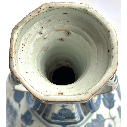 424 - A Chinese blue and white vase in the Yuan manner decorated with birds and double handle, ht. 34cm