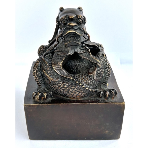 430 - A large Chinese bronze seal with dragon sat on top and seal mark to base, ht 16cm