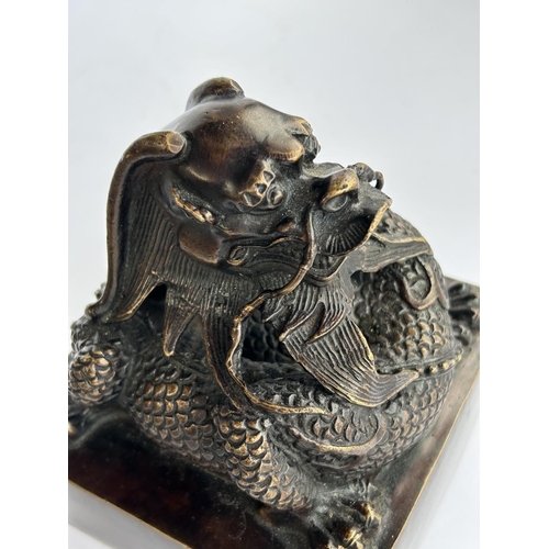 430 - A large Chinese bronze seal with dragon sat on top and seal mark to base, ht 16cm