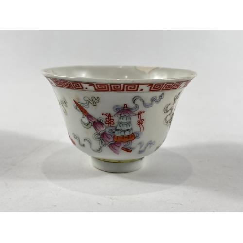 434 - A Chinese tea bowl with decoration of gifts to the outside, seal mark to base, Greek key border dia.... 