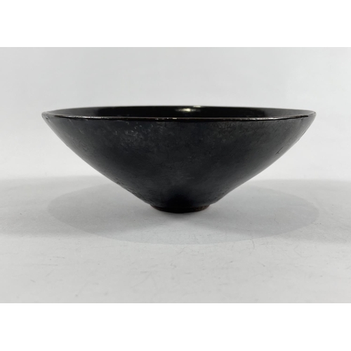 436 - A Chinese dark glazed bowl with small foot, leaf decoration in the glaze, 15cm dia