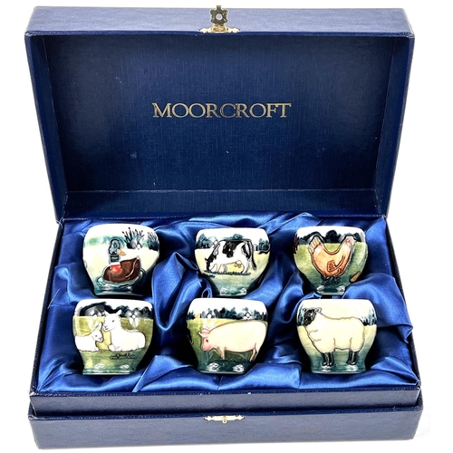 555 - A Moorcroft cased set of 6 eggcups depicting farm animals and birds, printed mark, etc.