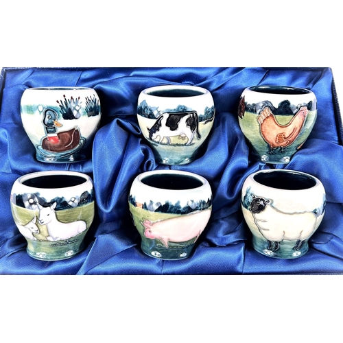 555 - A Moorcroft cased set of 6 eggcups depicting farm animals and birds, printed mark, etc.