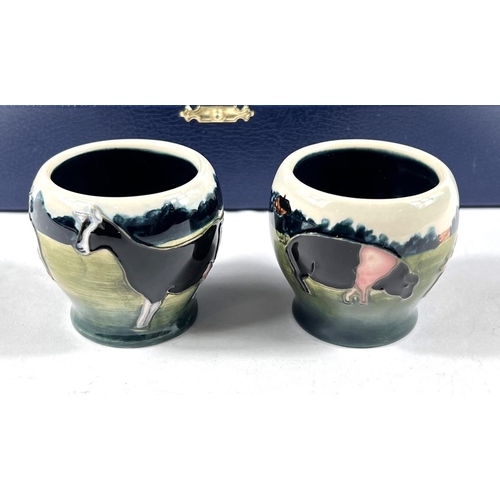 555 - A Moorcroft cased set of 6 eggcups depicting farm animals and birds, printed mark, etc.