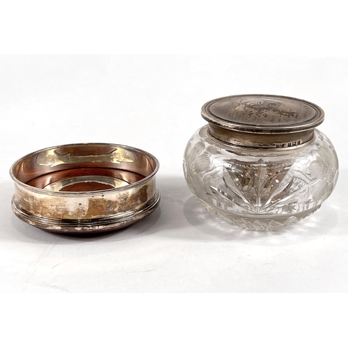 613 - A hallmarked silver coaster by Cars, a silver lidded cut glass trinket jar and a napkin ring