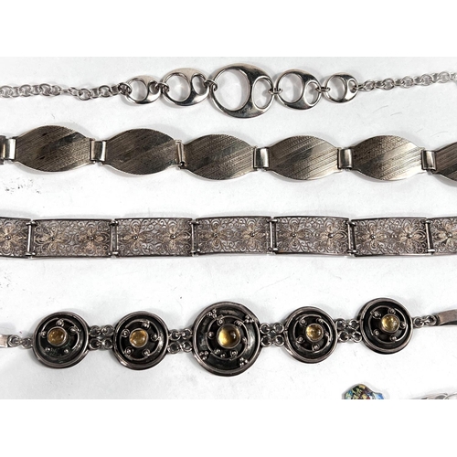 640 - 4 silver bracelets, a silver bangle, a silver charm bracelet with various charms and coins; a hallma... 