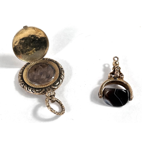 641 - A yellow metal fob set with headstone; a yellow metal pendant mourning locket opening to woven hair ... 