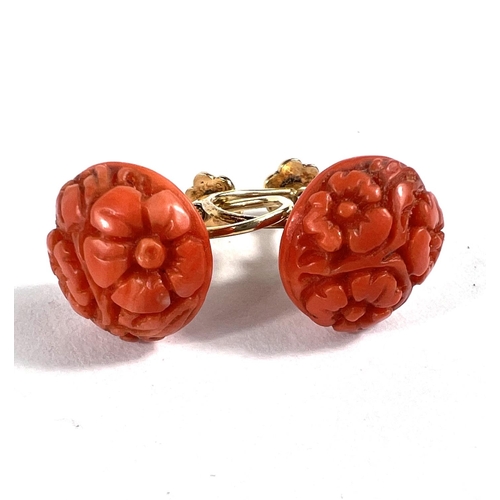 643 - A pair of screw back carved coral earrings in yellow metal fixtures, stamped 15c indistinctly, 4.4gm... 