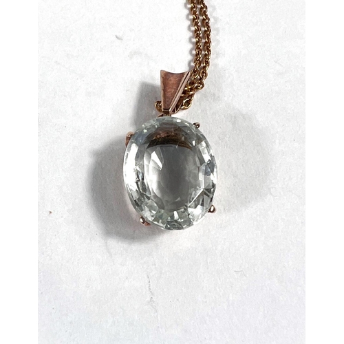 644 - An oval aquamarine pendant in yellow metal surround, stamped 12k on a 9ct chain, stone 13mm x 10mm, ... 