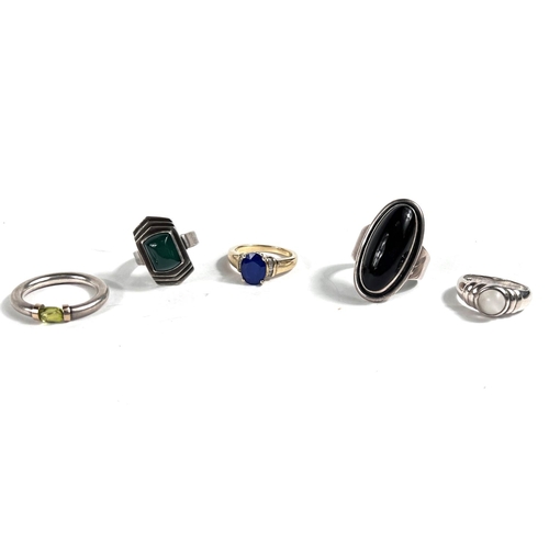 645 - A silver ring set with peridot; a silver gilt ring set with oval blue synthetic sapphire & small... 