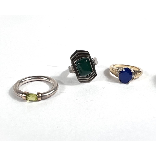 645 - A silver ring set with peridot; a silver gilt ring set with oval blue synthetic sapphire & small... 