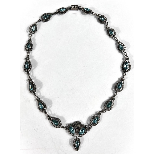 650 - A white metal necklace formed from tear drop shaped pierced links set with clear and aquamarine colo... 