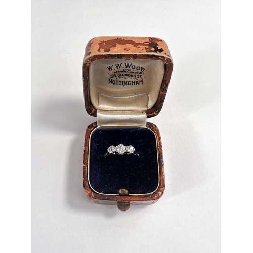 670 - A white metal ring stamped '18ct plat', set 3 diamonds, central stone 4mm approx (worn thin) 2.2 gm.... 