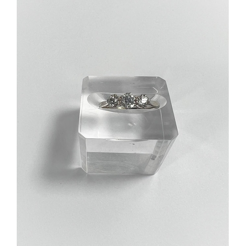 670 - A white metal ring stamped '18ct plat', set 3 diamonds, central stone 4mm approx (worn thin) 2.2 gm.... 