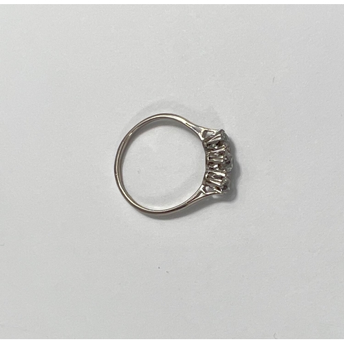 670 - A white metal ring stamped '18ct plat', set 3 diamonds, central stone 4mm approx (worn thin) 2.2 gm.... 