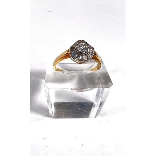 708 - A lady's gold dress ring set with central diamond surrounded by a wavy band of baguette diamonds, ce... 