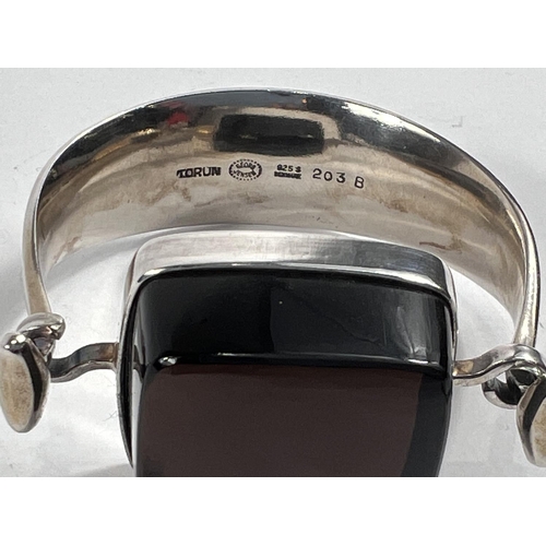 726 - Georg Jensen:  a tapering silver bangle designed by Vivianna Torun Bulow-Hübe, the top set... 