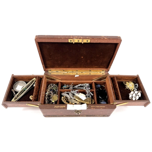 731 - A selection of costume jewellery in leather cantilevered jewellery box