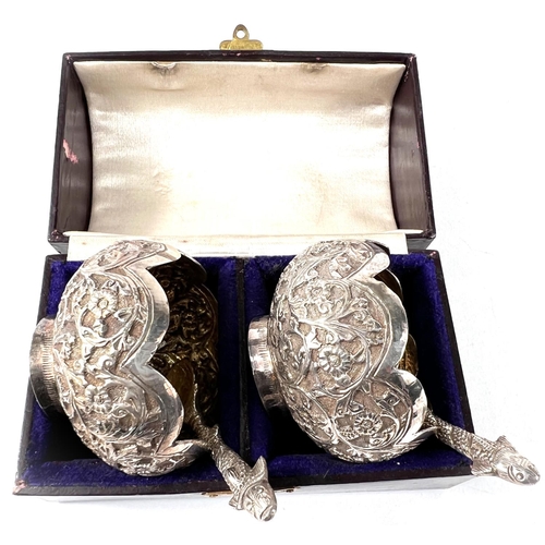 746 - A cased pair of oriental lotus flower shaped white metal salts with extensive relief decoration of s... 