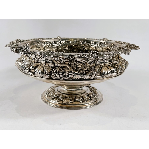 759 - A hallmarked silver circular rose bowl on pedestal base, with relief decoration of fruiting vines, S... 