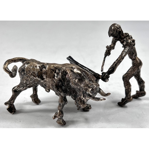 762 - A cast white metal matador and bull, one with foreign marks, length of bull 8cm