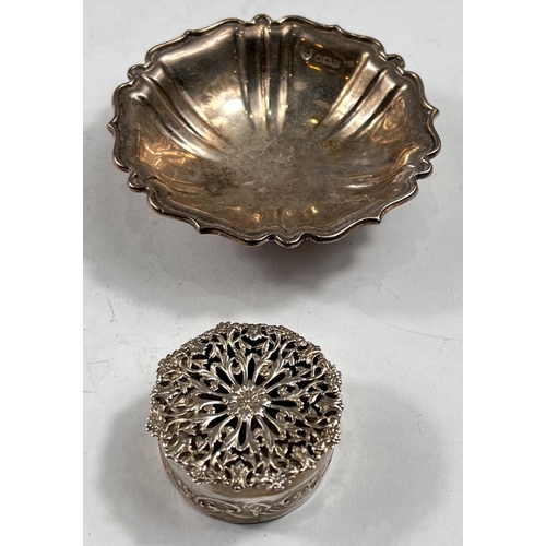 768 - A small circular box the lid with pierced decoration, London 1907, 5cm; a hallmarked silver cir... 