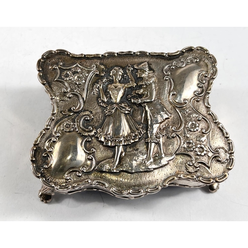 770 - A hallmarked silver shaped rectangular jewellery box, the hinged lid decorated in relief with an 18t... 