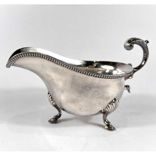 777 - A hallmarked silver Georgian style sauce boat with ribbed rim, on hoof feet, Sheffield 1957, 7.9oz