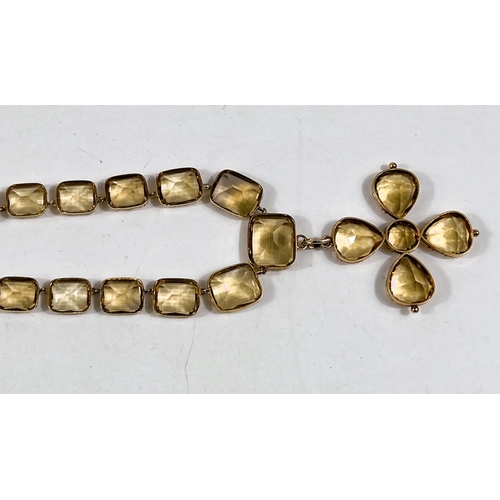 797 - A yellow metal necklace formed from graduating rectangular citrines, each held in an embossed band, ... 