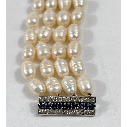 801 - A bracelet formed from 4 rows of fresh water pearls, the vertical clasp and 2 bars set 44 white &... 