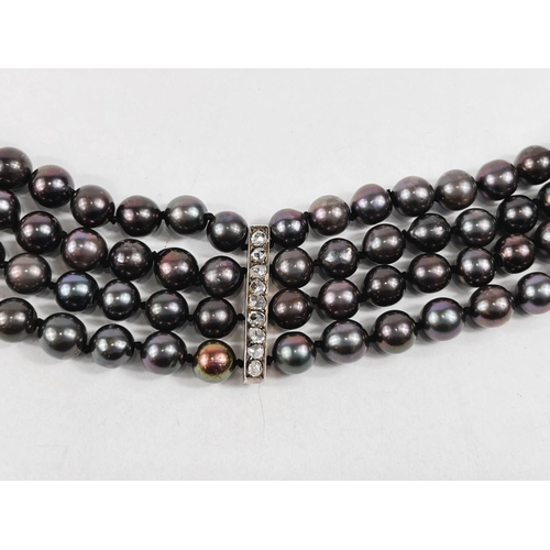 802 - A choker necklace formed from 4 strands of black pearls, 3 vertical decorative bars each set 9 old c... 