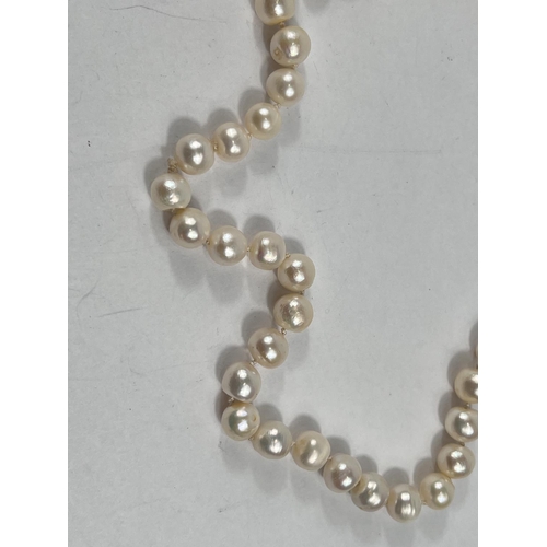 803 - A single strand necklace of 60 pearls, approx, average diameter 10mm, with natural blemishes, length... 